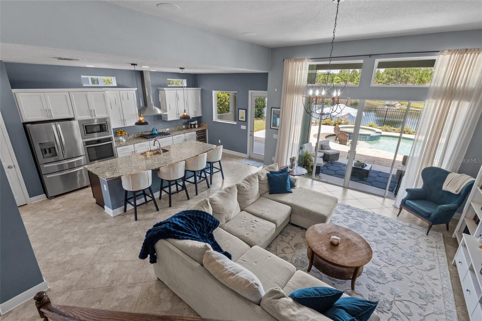 Large gathering room connects seamlessly to the kitchen, dining, and covered patio