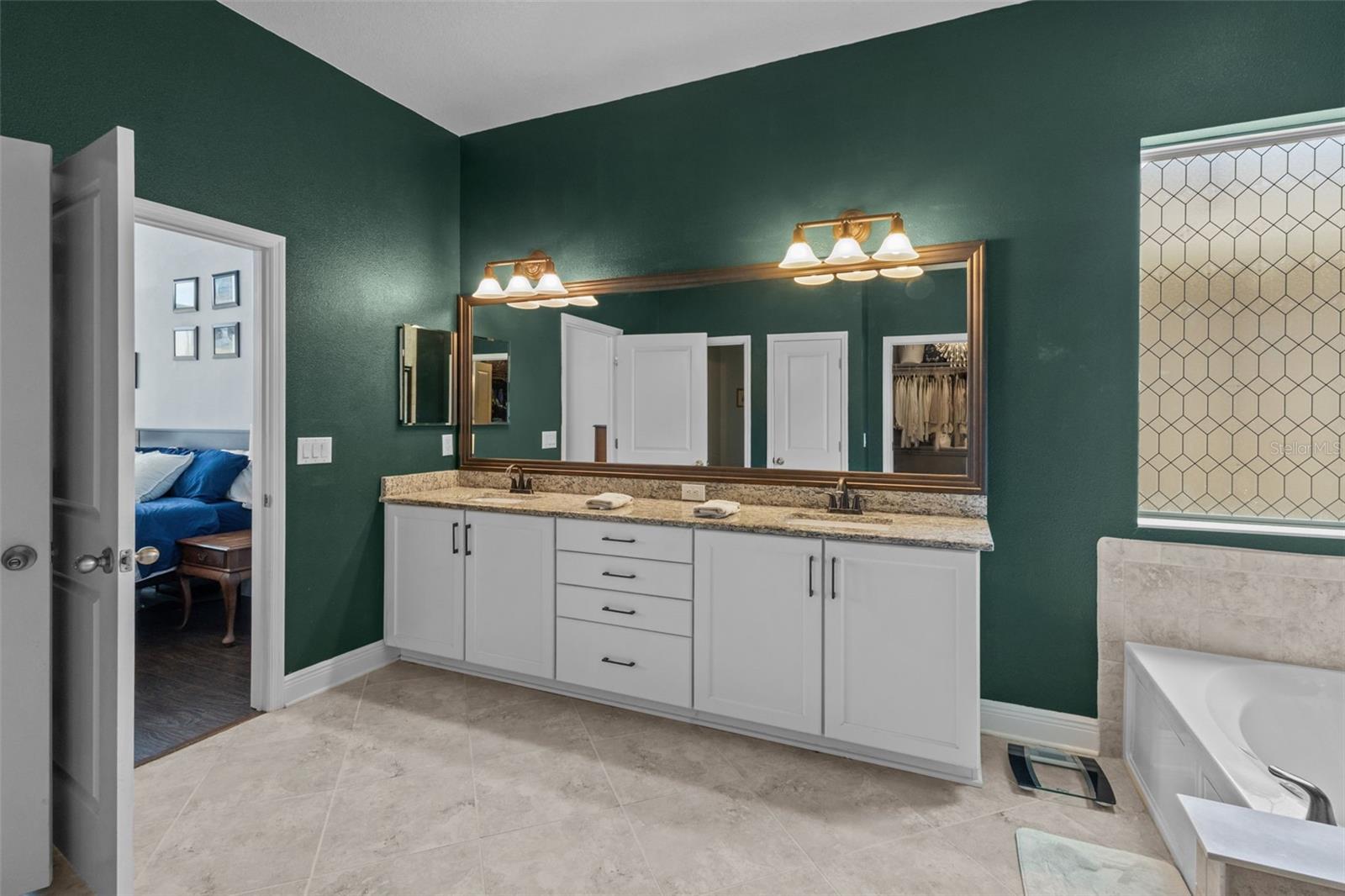 Primary bath includes dual sinks, garden tub, walk-in shower, and large walk-in closet.