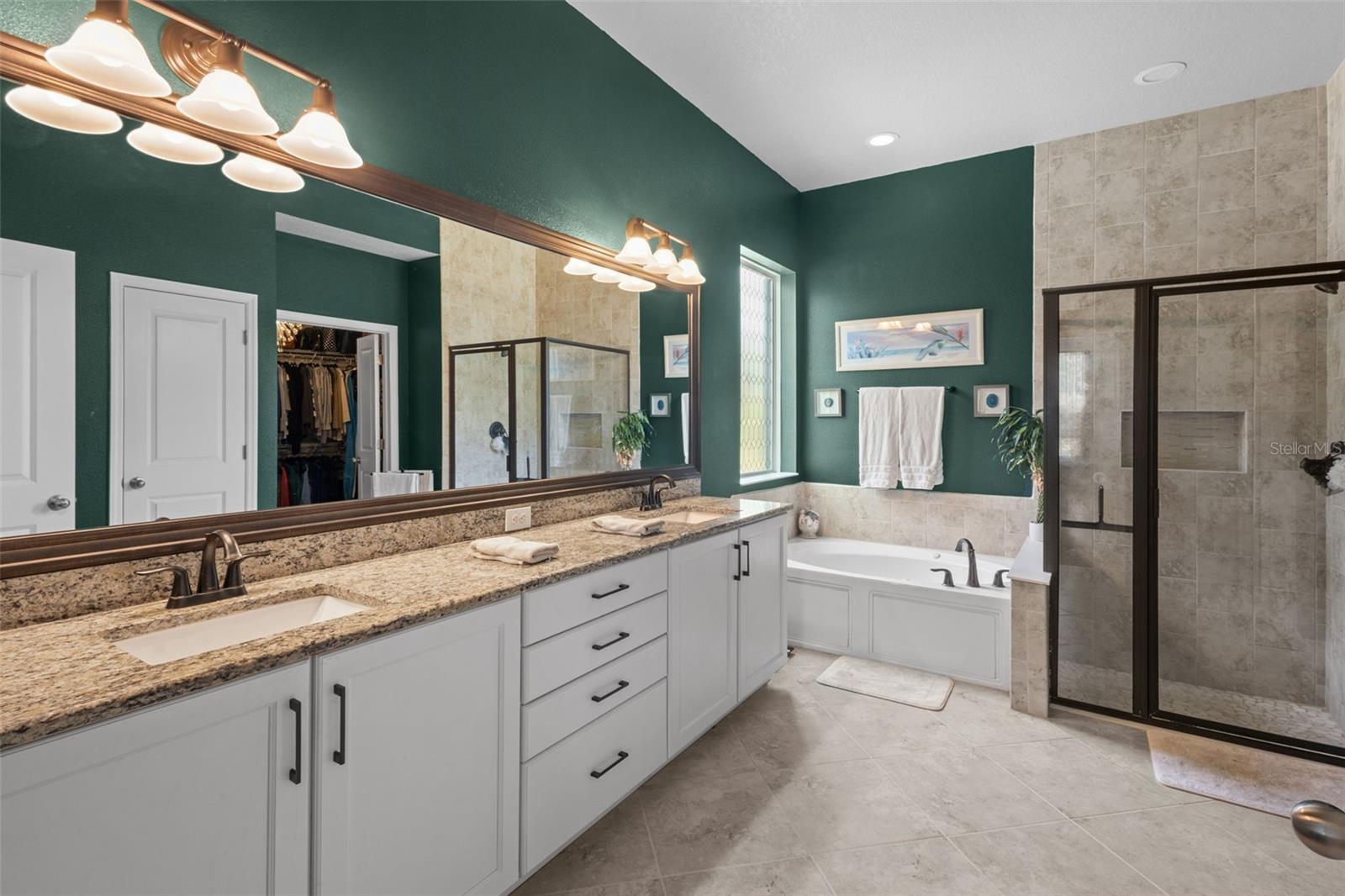 Primary bath includes dual sinks, garden tub, walk-in shower, and large walk-in closet.