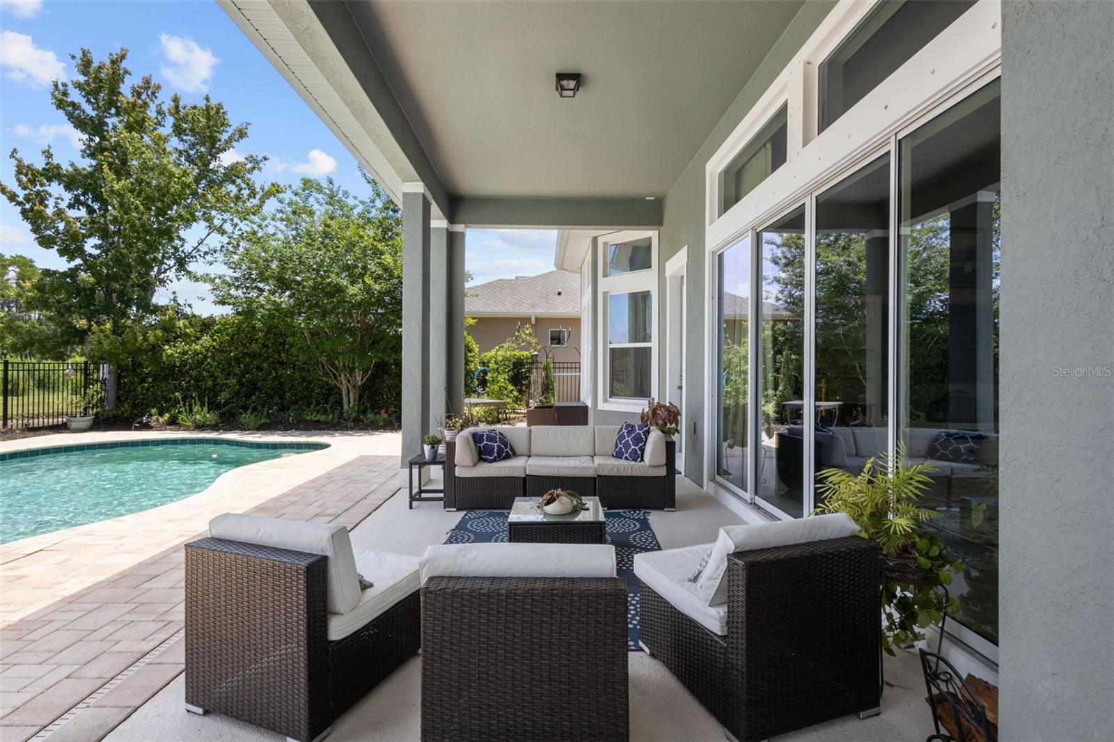 Large covered patio connects directly to the living room through sliding glass doors