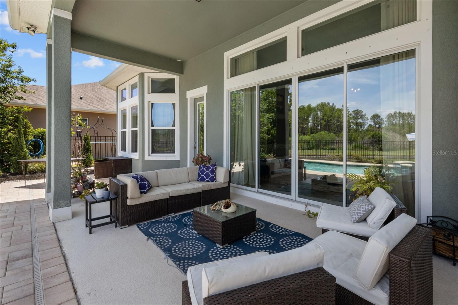 Large covered patio connects directly to the living room through sliding glass doors