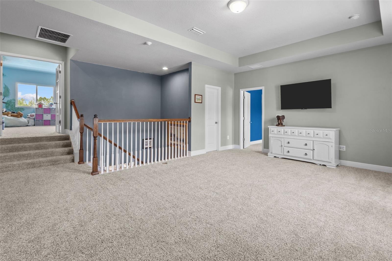 Spacious loft ideal for media, work, play, or additional gathering space
