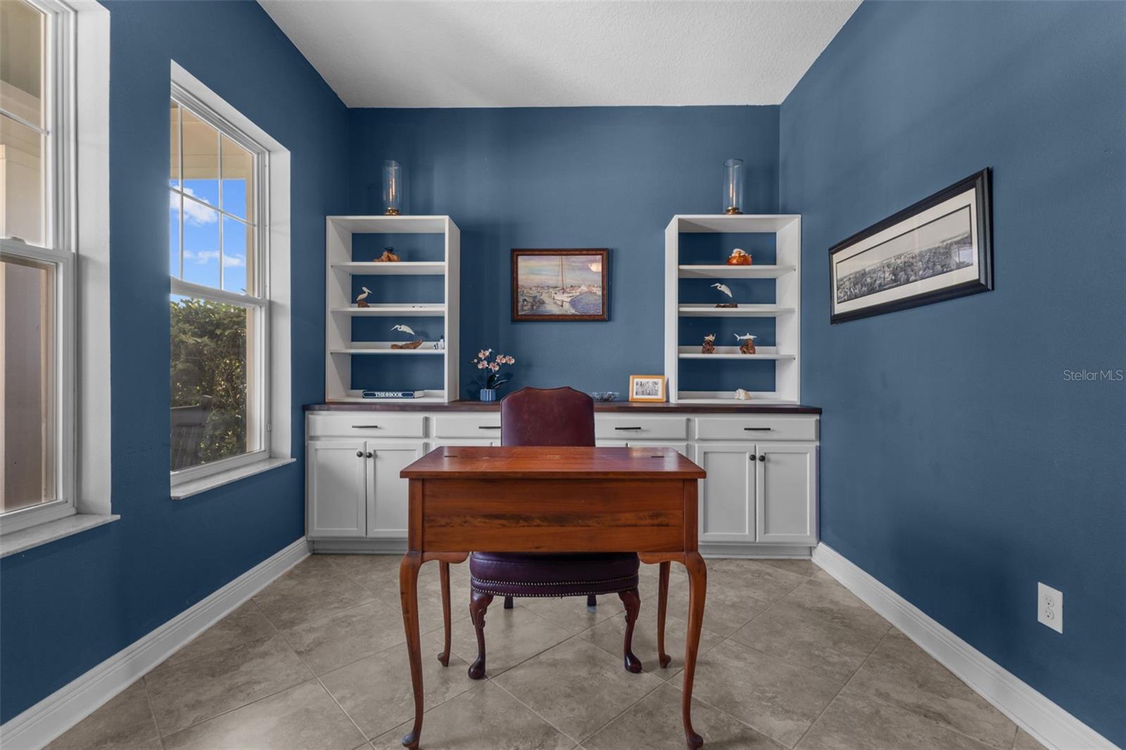 Open front office with built-in cabinetry for workspace and storage