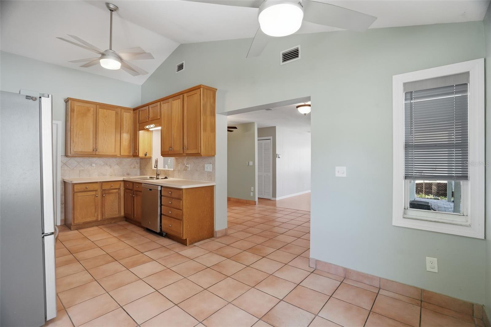 Vaulted ceiling kitchen with high-rise cabinets for ample storage