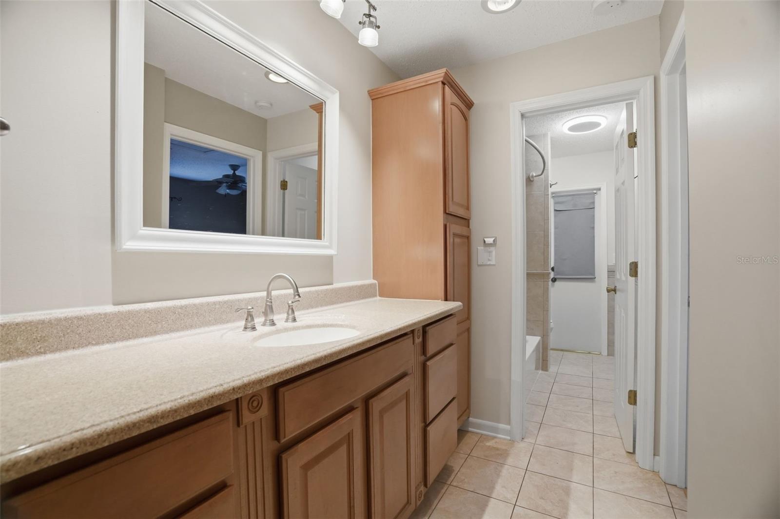 Guest bathroom / walk way to guest bedroom three and door showing separate shower and toilet area