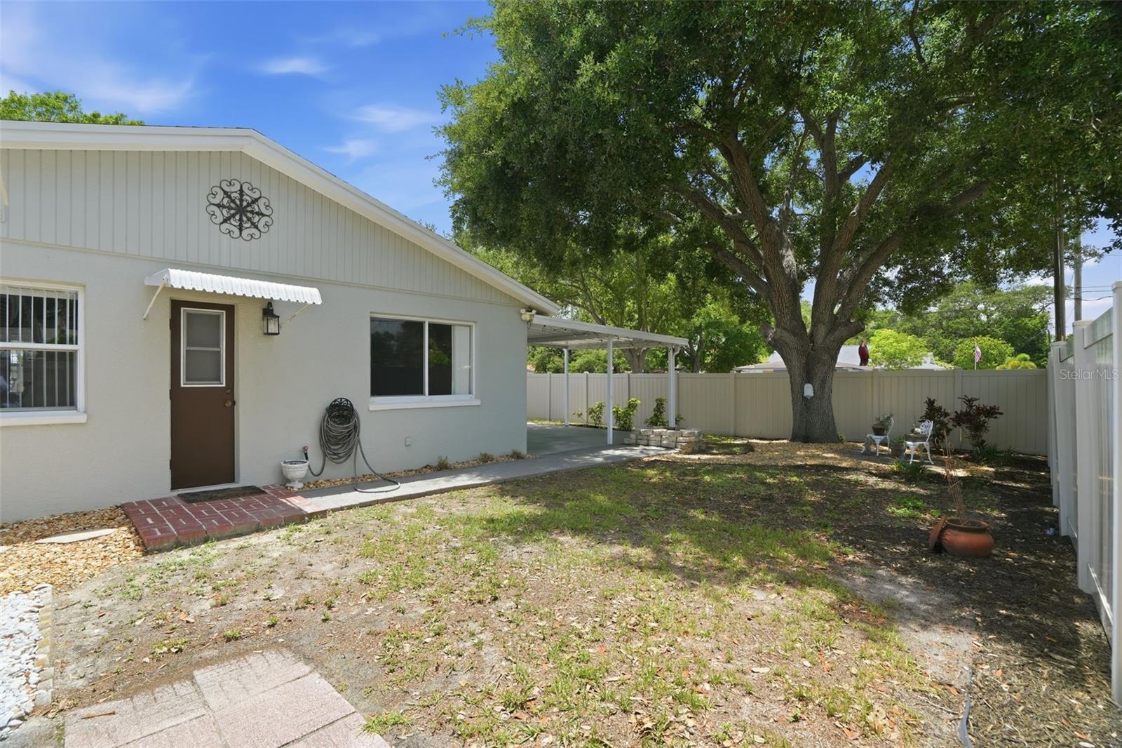 Rear of property showing the door that accesses guest bath. Great for a pool bath if you want to add a pool!