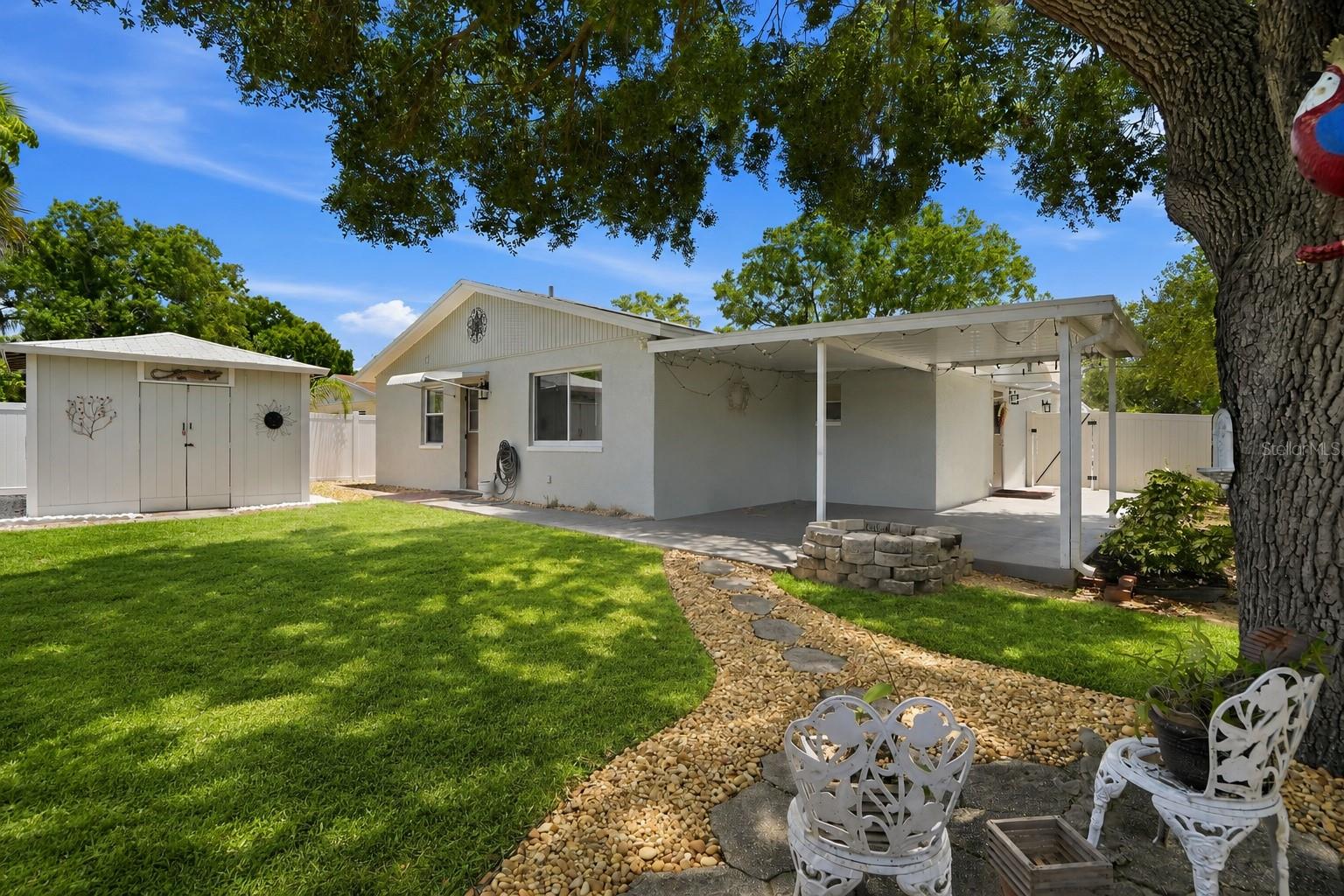 Backyard retreat with covered patio and large shed