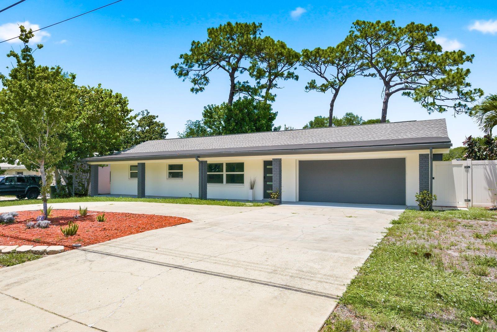 The home features a horseshoe-shaped drivey for esy access In and OUT.