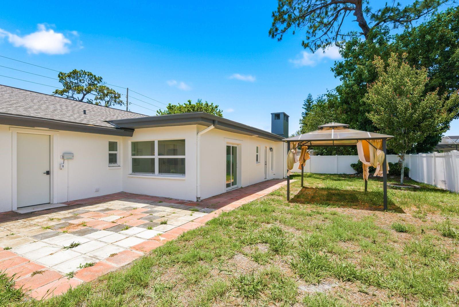 The backyard offers multiple areas for seating and entertaining.