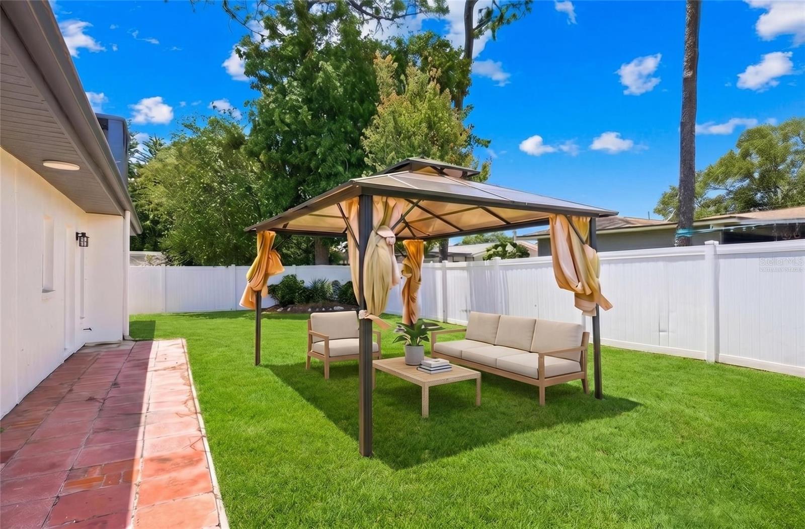Virtually staged with furniture and enhanced landscaping to help showcase the home’s potential and inspire ideas for outdoor living and entertaining.