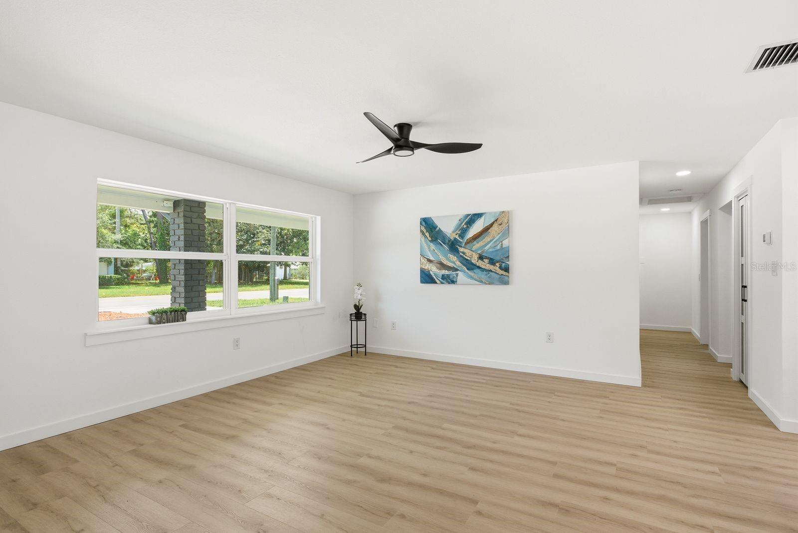 Living room features large new windows that bring in an abundance of natural light throughout the space.