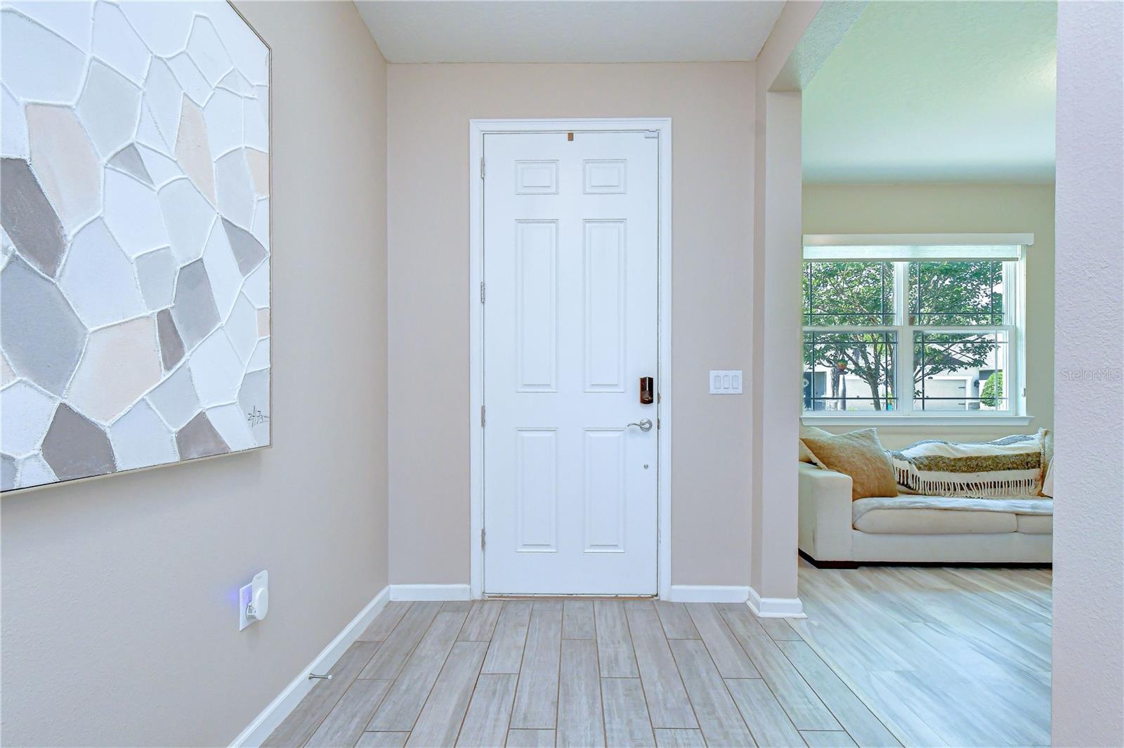 Inviting entry opening into the home's bright interior.