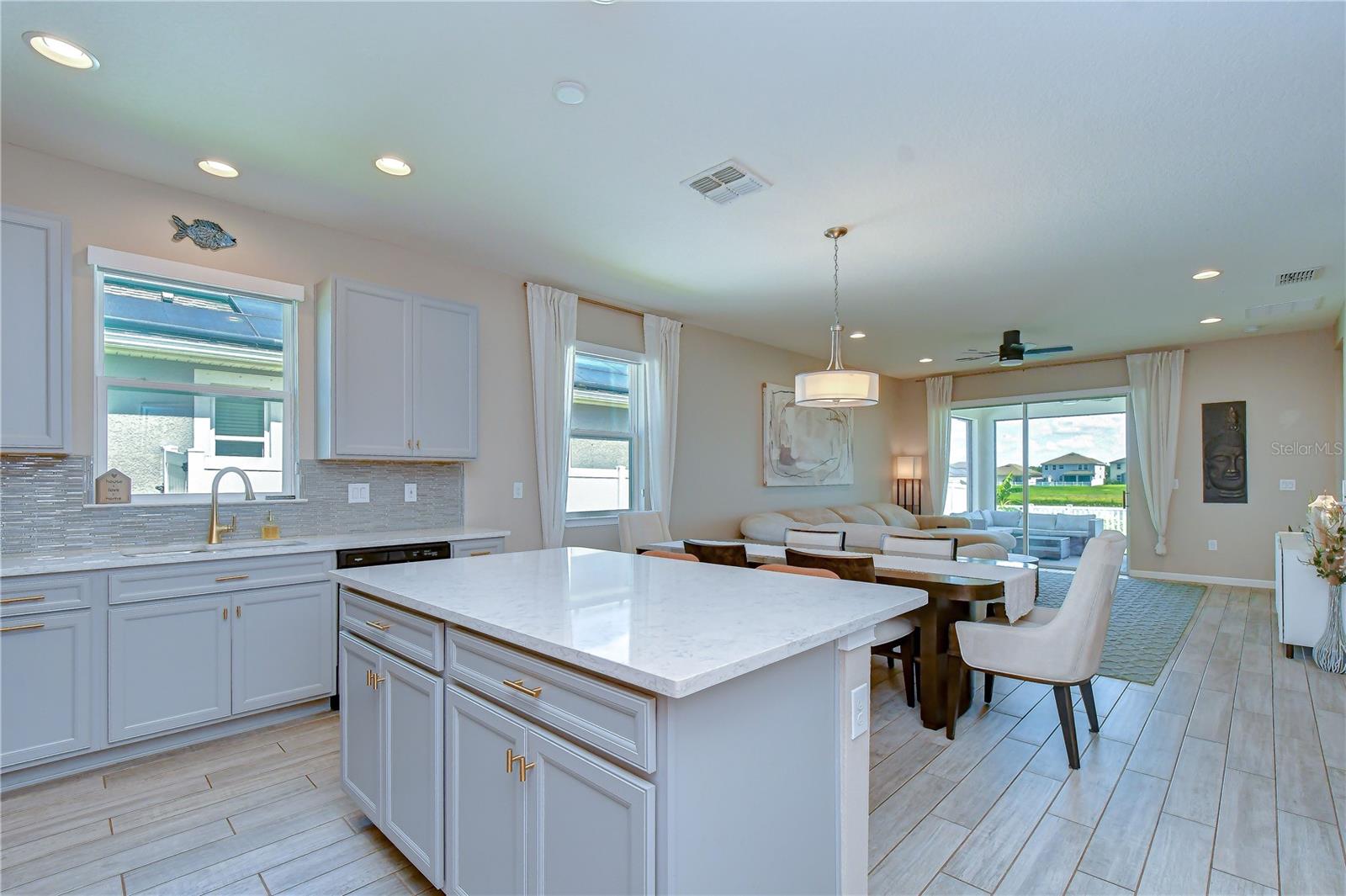 Seamless flow between living, dining, and kitchen areas.