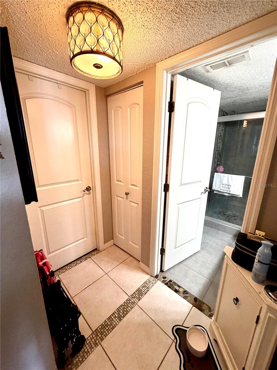 Hallway to 2nd Bathroom and Guest room to the left. Linen closet in the center