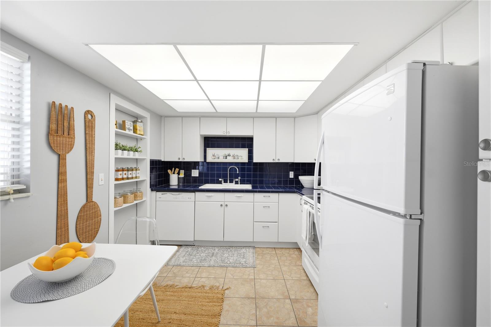 charming kitchen with vintage colors , lots of cupboards and a cozy eat - in dining area