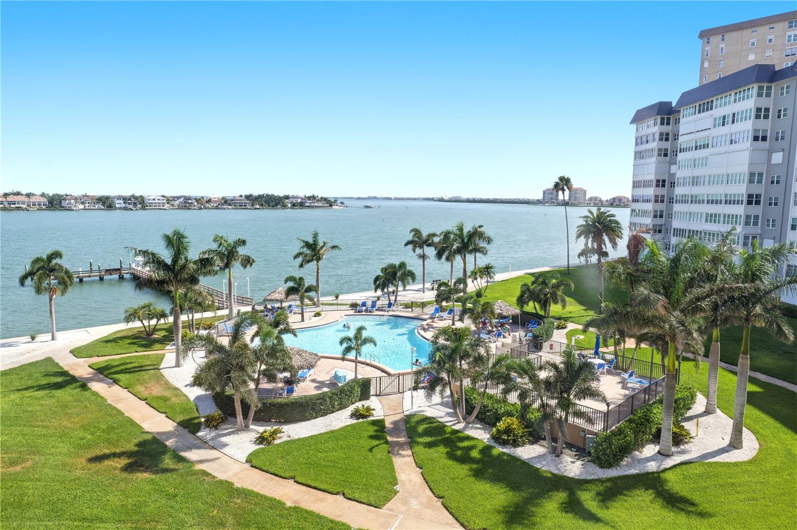 one of many heated pools on the property with wide open views of Boca Ciega Bay and deep water access leading to the Gulf of Mexico