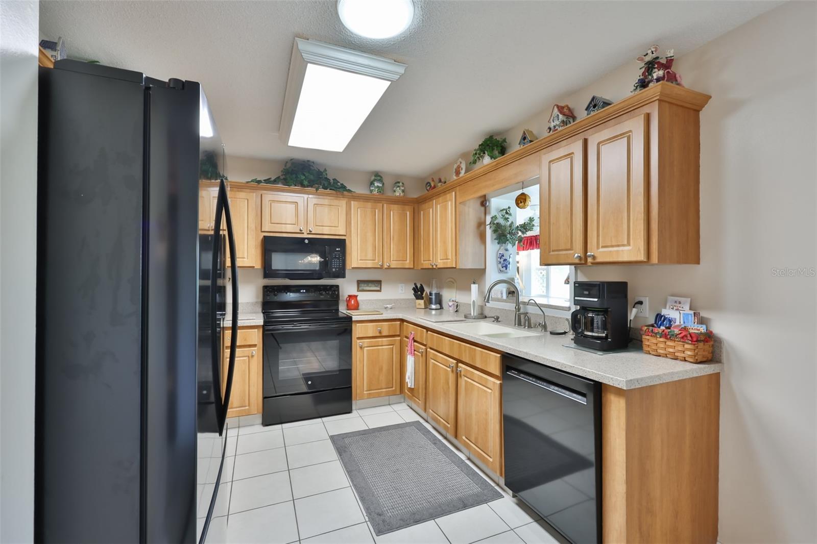 Kitchen, Wood Cabinets, Corian Countertop, Pantry, & Solar Tube