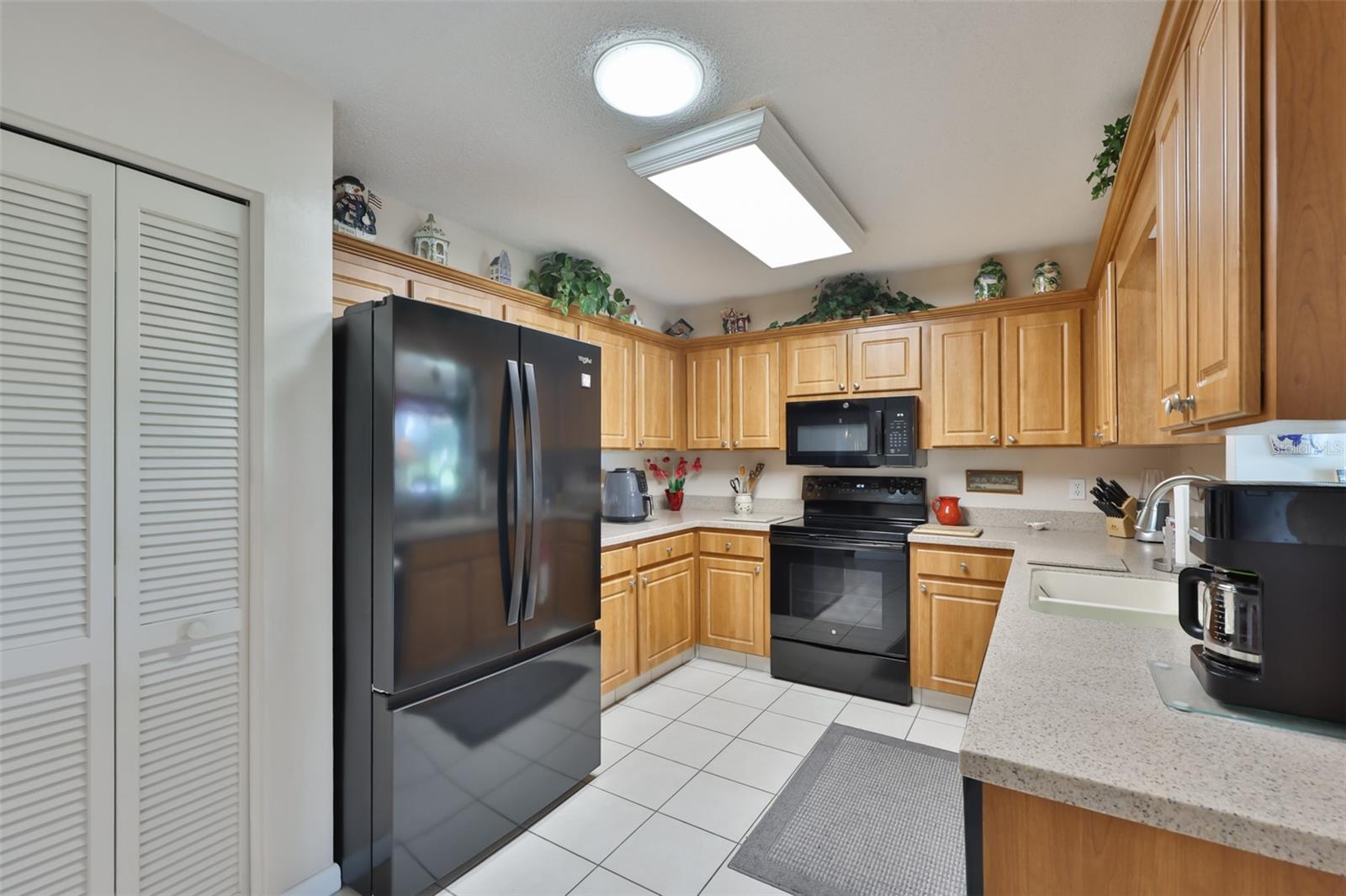 Kitchen, Wood Cabinets, Corian Countertop, Pantry, & Solar Tube