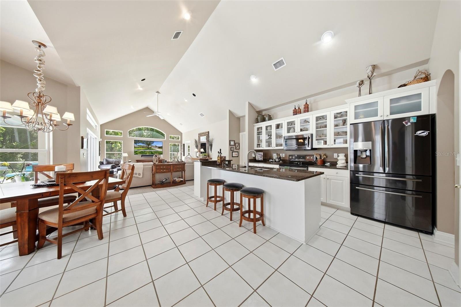Large open kitchen area with eat in kitchen area overlooking the pool and conservation area.
