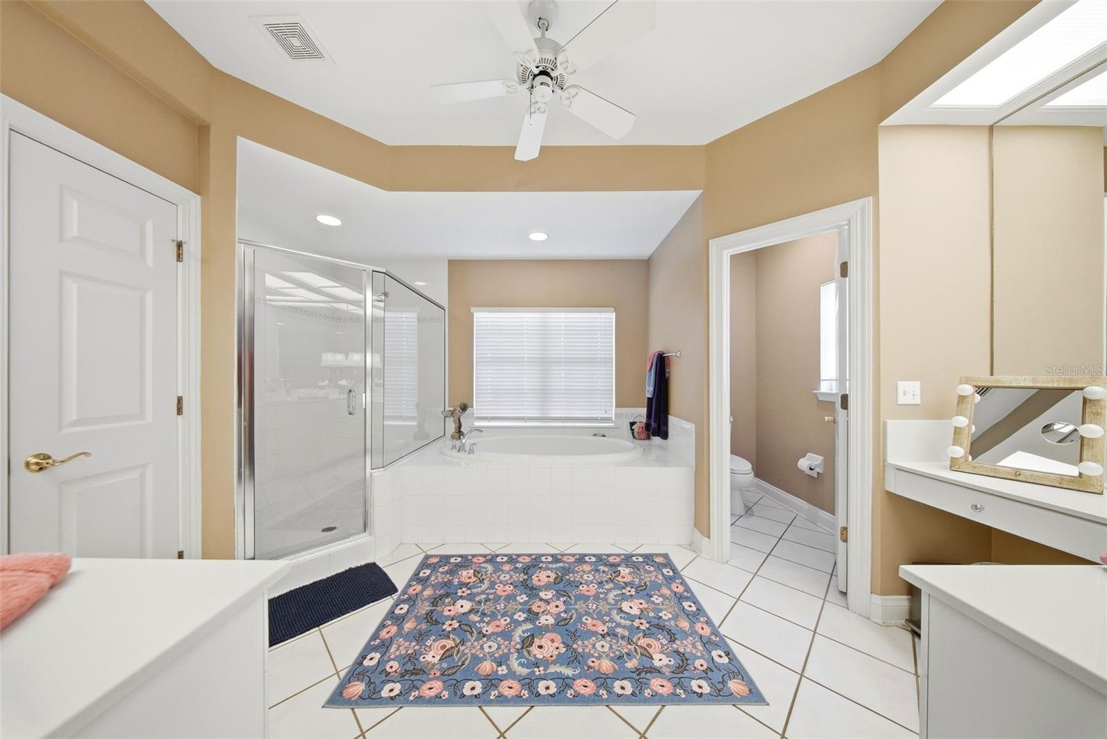 Large primary bathroom with jetted tub, shower, 2 large vanities with dual sinks.