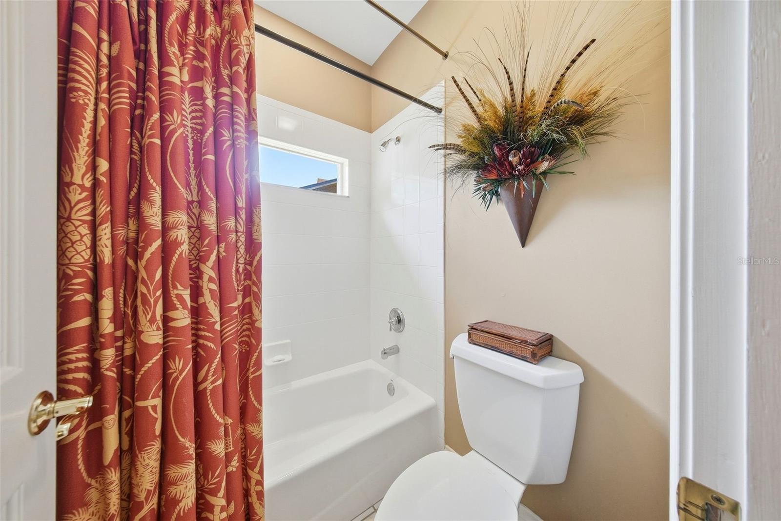 "Jack and Jill bathroom" with tub and shower in between bedroom #2 and bedroom #3.