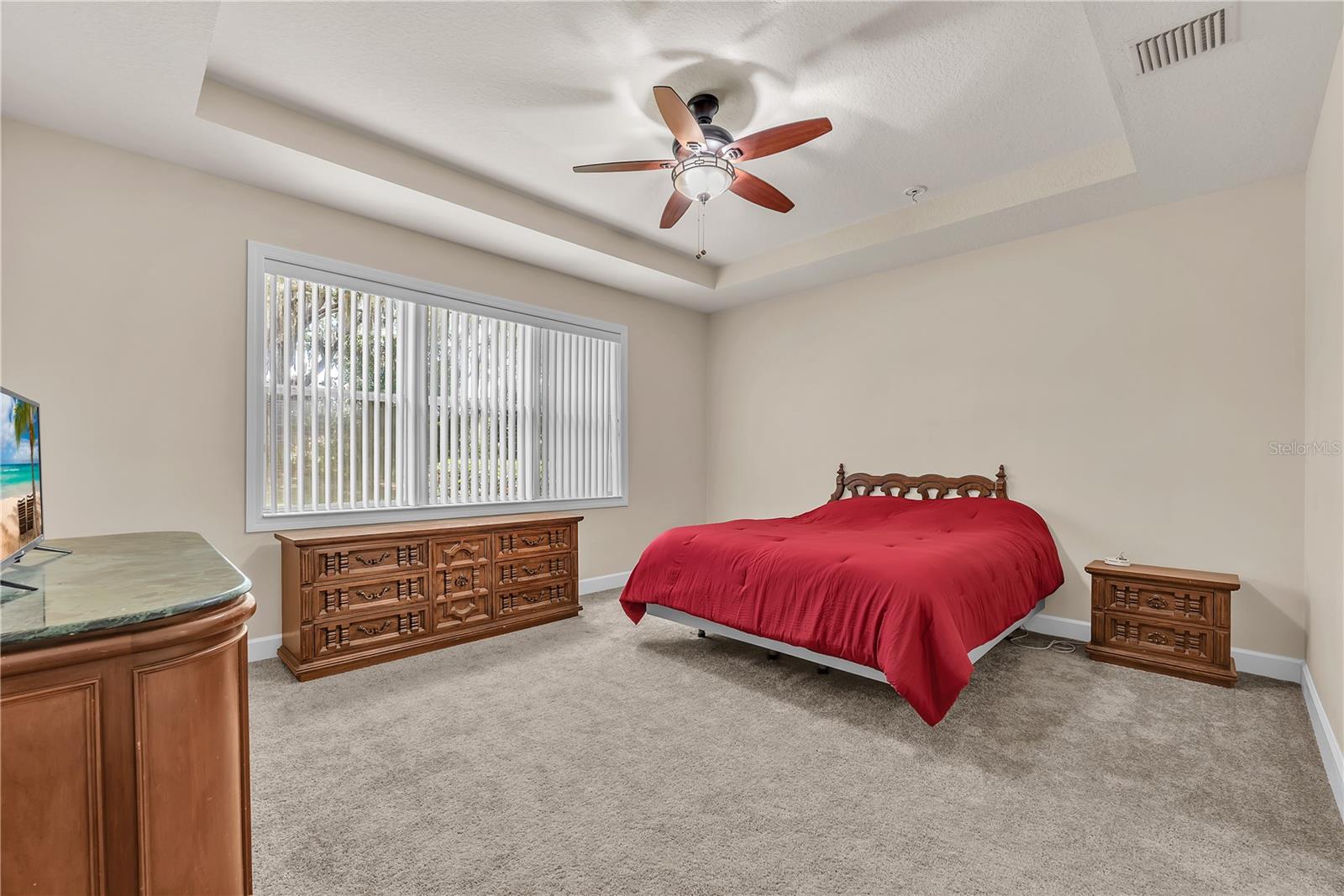 The oversized primary suite offers a tray ceiling, two walk-in closets and a luxurious ensuite bathroom.