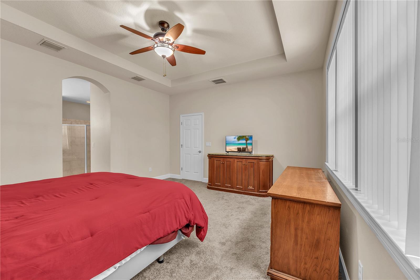The spacious primary suite is tucked away at the rear of the home in this three-way split bedroom layout providing exceptional privacy for everyone.