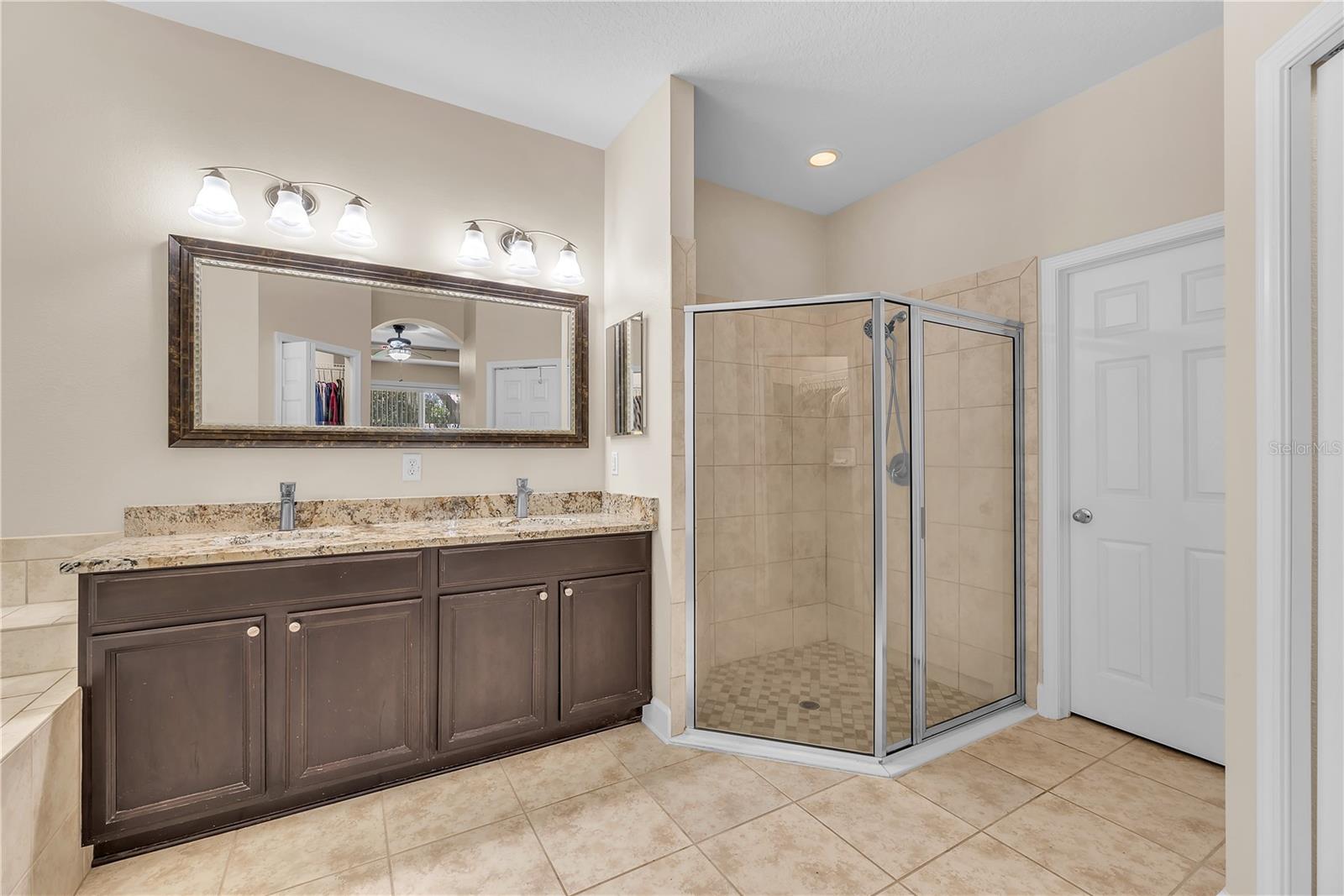 This glass walk-in shower has a handy built-in bench.