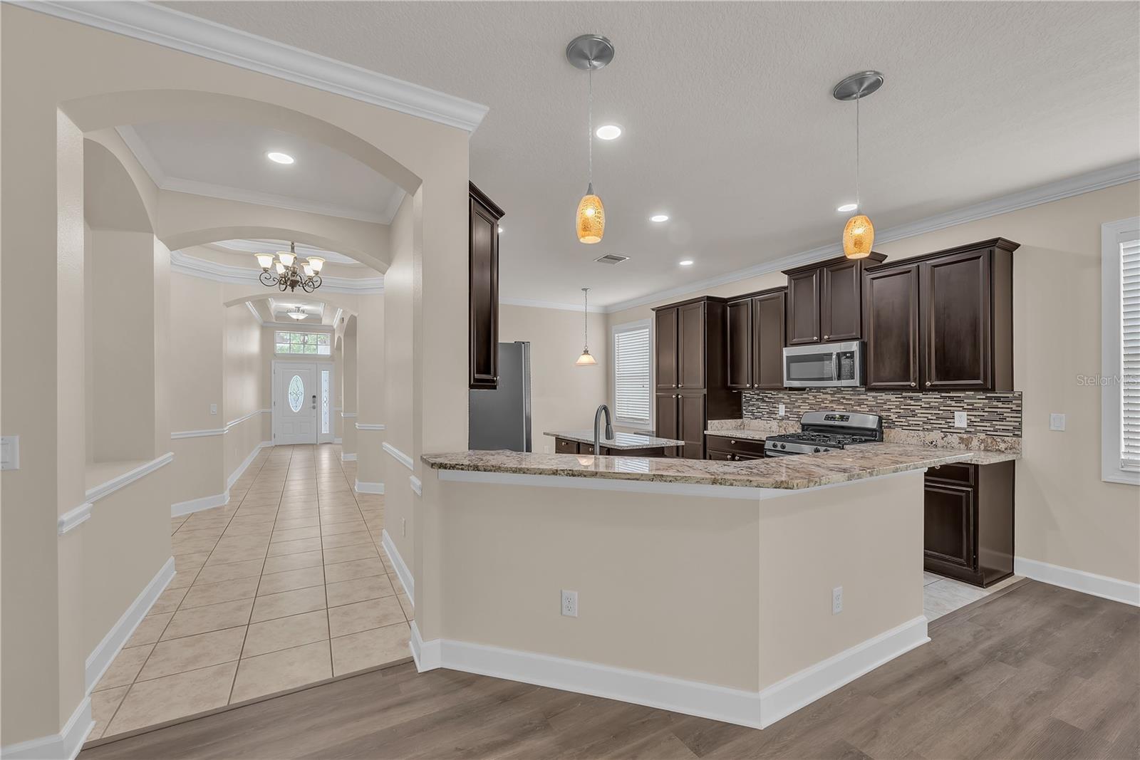 Offering both style and practicality, the breakfast bar provides extra seating and a convenient place to serve refreshments.