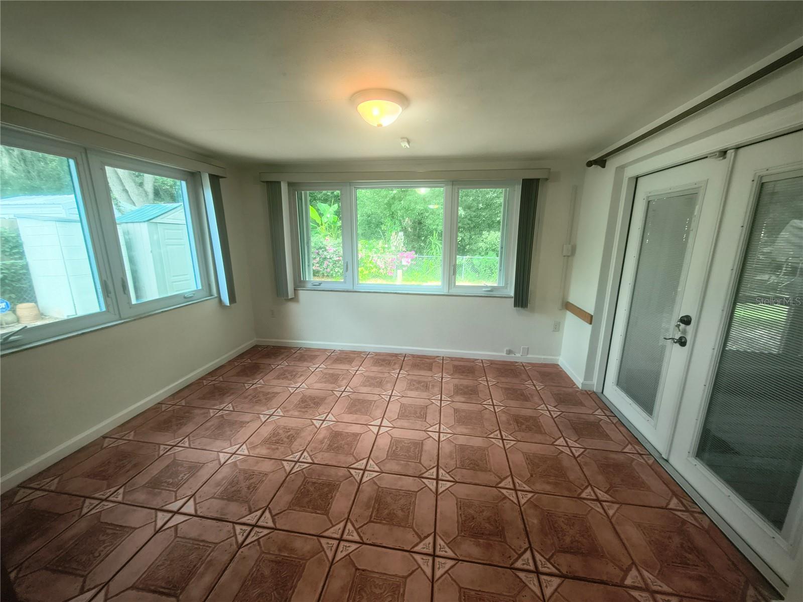 Bright Cheery Famiily Room has Hurricane Shutters and new windows