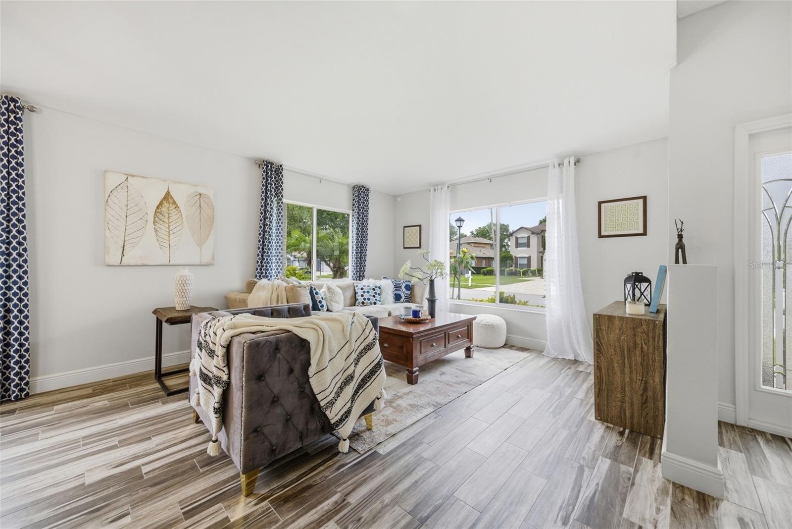 tall ceiling, spacious living area with so much natural light
