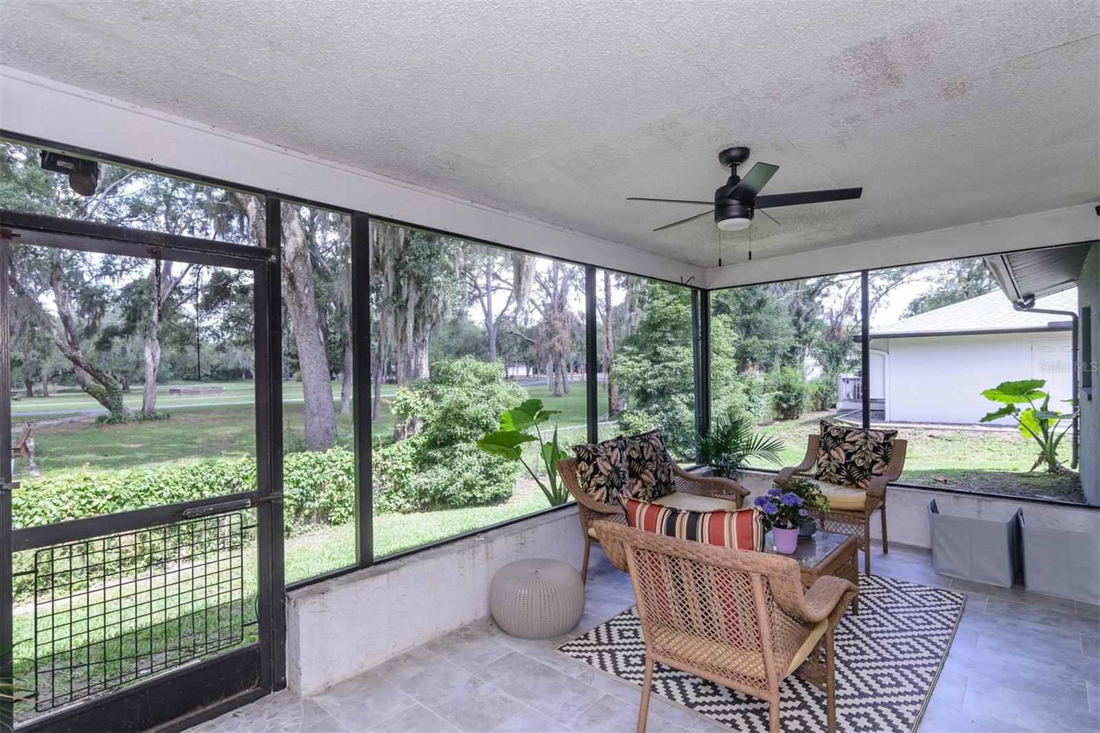NEWLY TILED OUTDOOR SCREENED PATIO