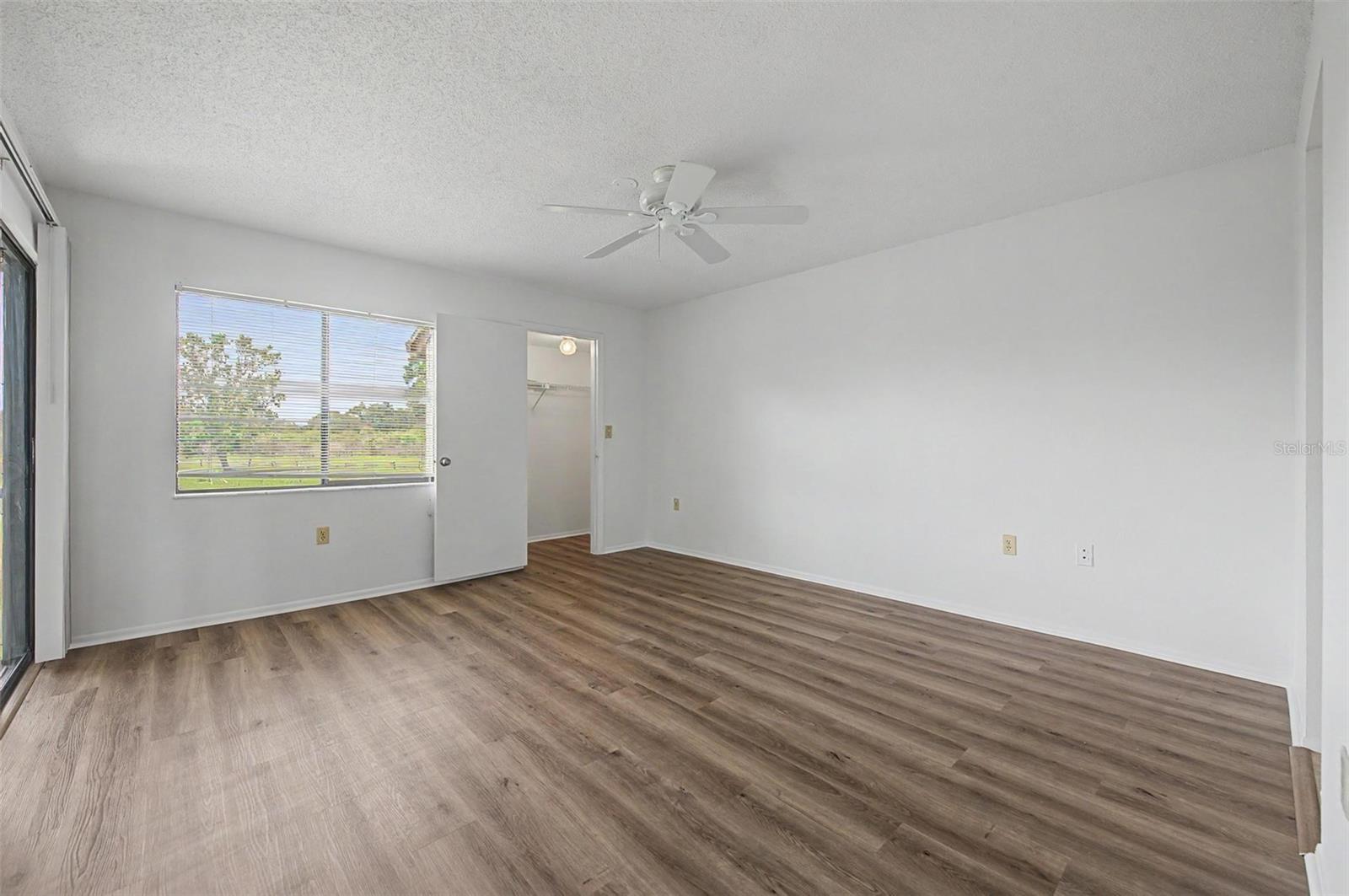Primary Bedroom offers en-suite bathroom, 3 walk-in closets and sliders to the screened balcony.