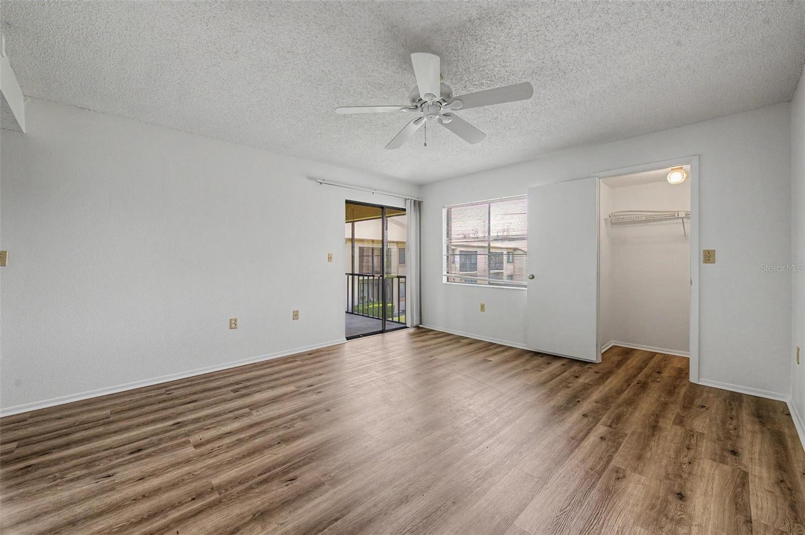 Primary Bedroom offers en-suite bathroom, 3 walk-in closets and sliders to the screened balcony.