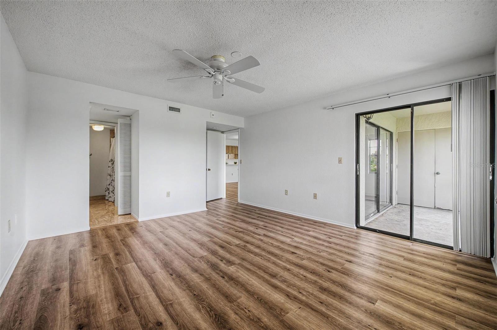 Primary Bedroom offers en-suite bathroom, 3 walk-in closets and sliders to the screened balcony.
