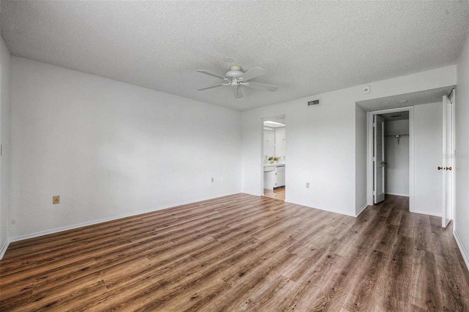 Primary Bedroom offers en-suite bathroom, 3 walk-in closets and sliders to the screened balcony.