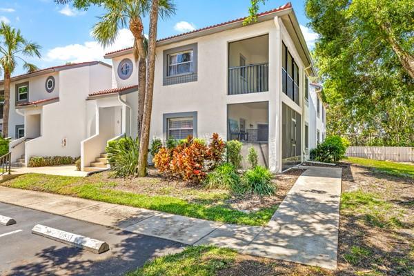Unique to this particular unit, a sidewalk approach with no stairs lead to the home's screened porch.