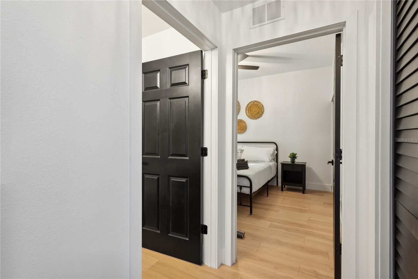View of bedroom and bathroom door from foyer