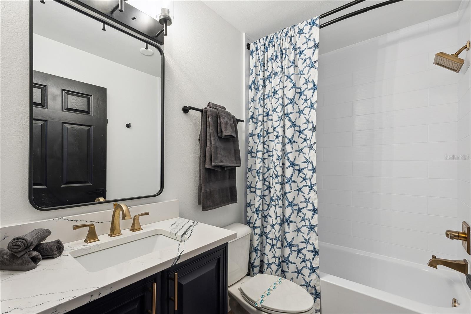 Full bathroom with Cambria Quartz "Portrush" series luxury countertops