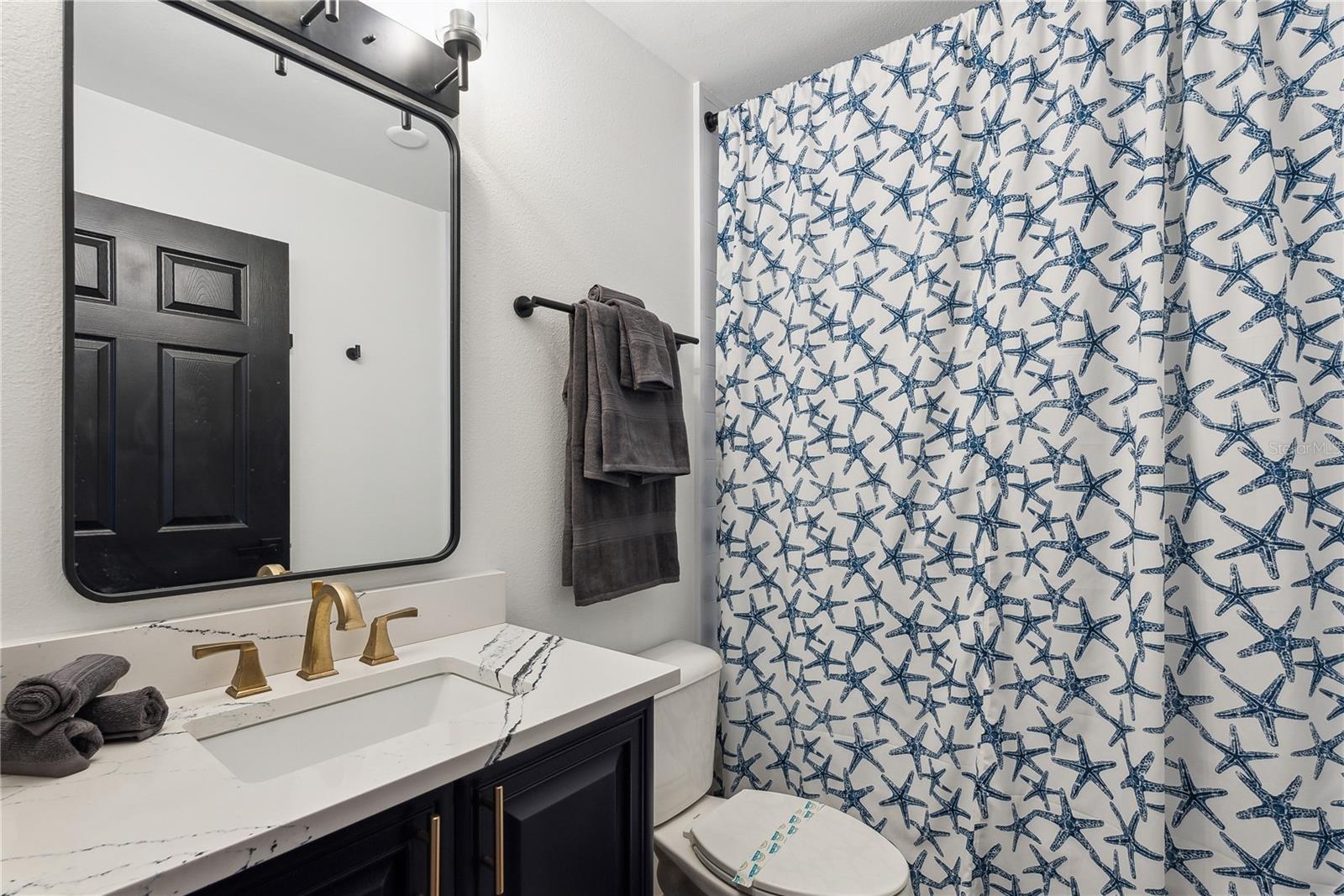 Full bathroom with Cambria Quartz "Portrush" series luxury countertops