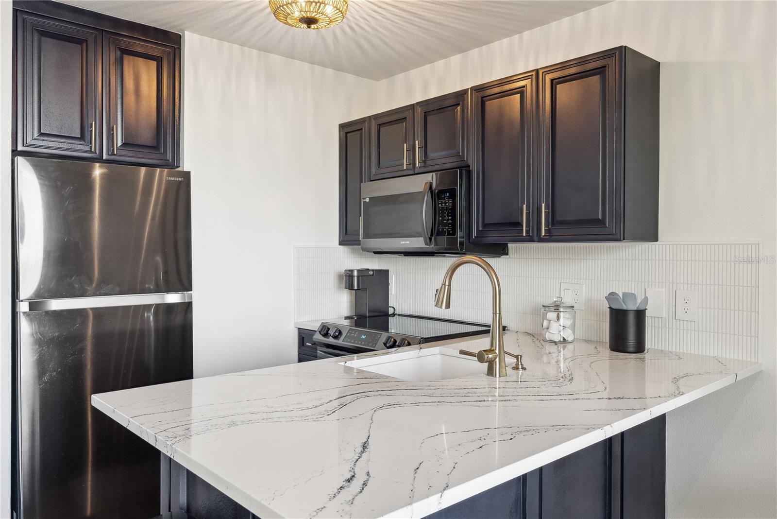 Spacious kitchen with Cambria Quartz "Portrush" series luxury countertops and 2023 new appliances