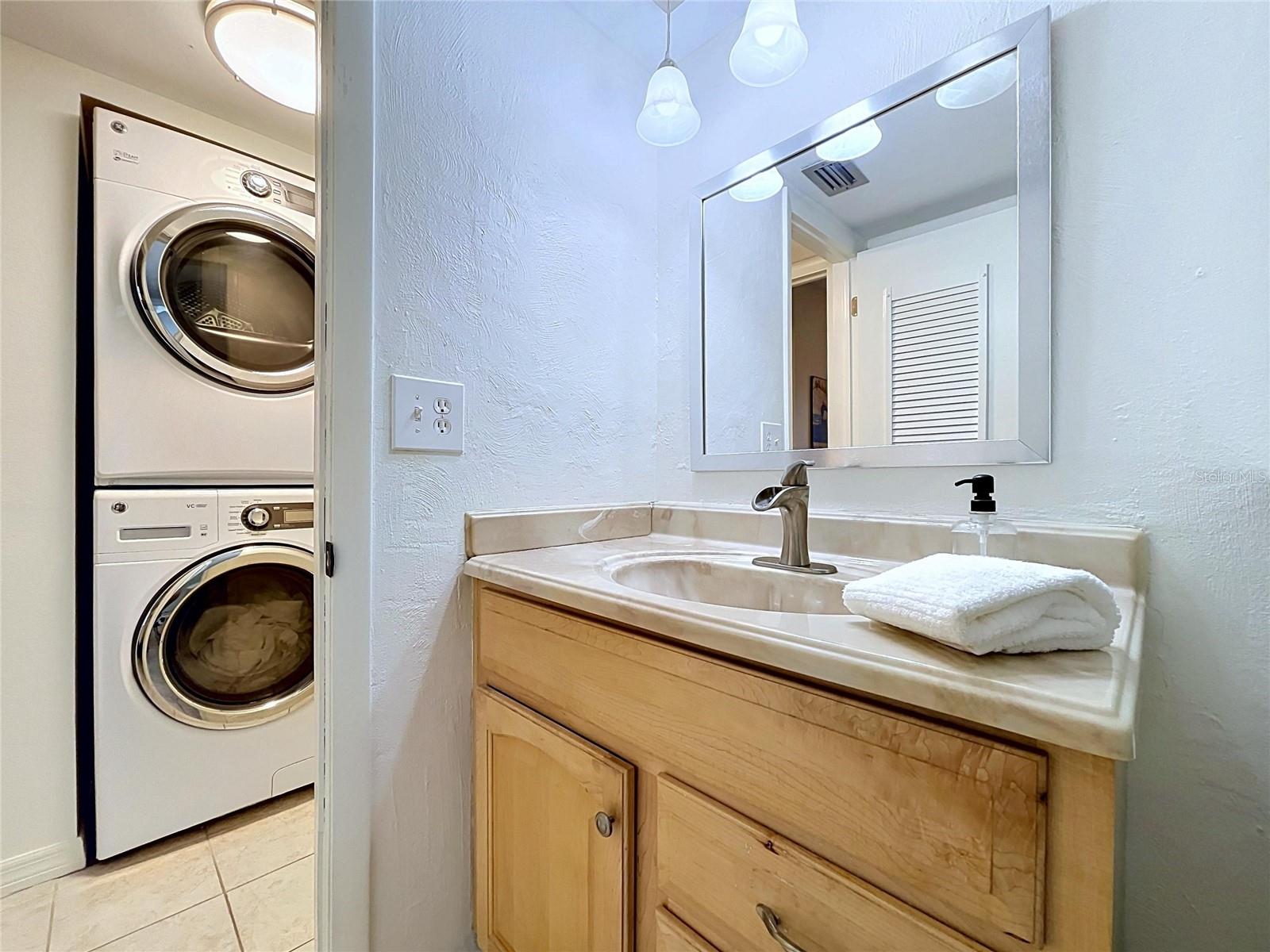 Guest bathroom (view of washer/dryer in unit)