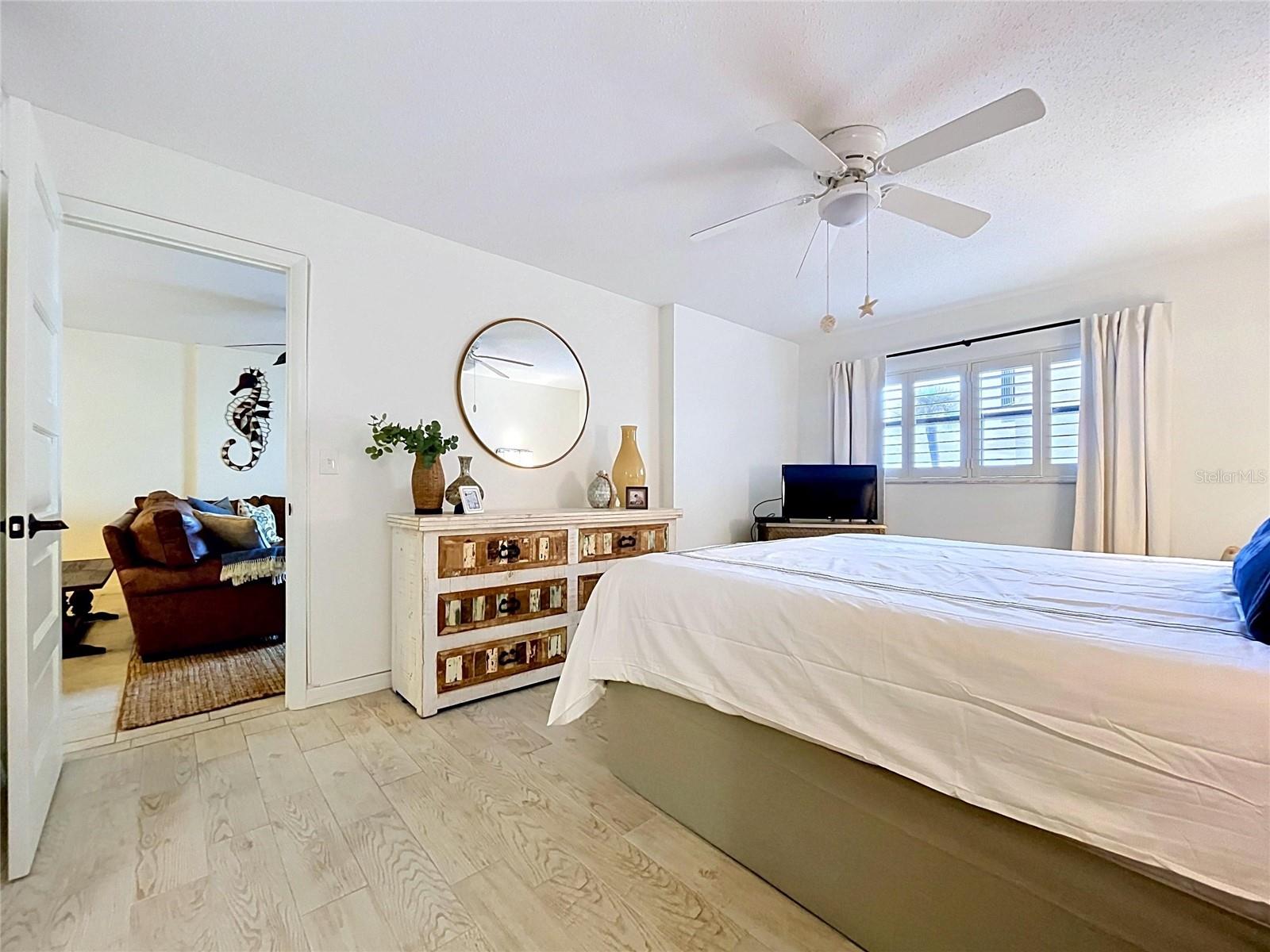 Primary bedroom has window view of beach