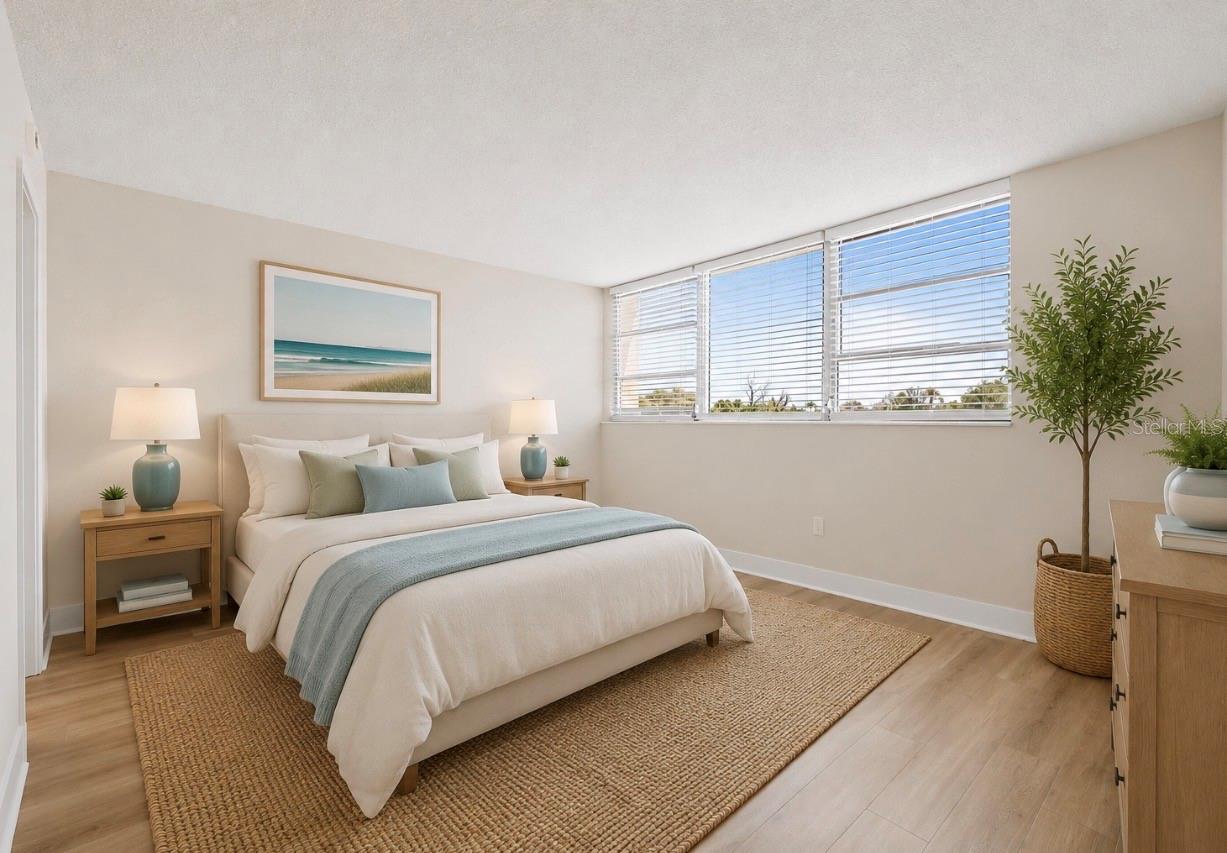Spacious primary bedroom with walk in closet, ensuite bath and water views