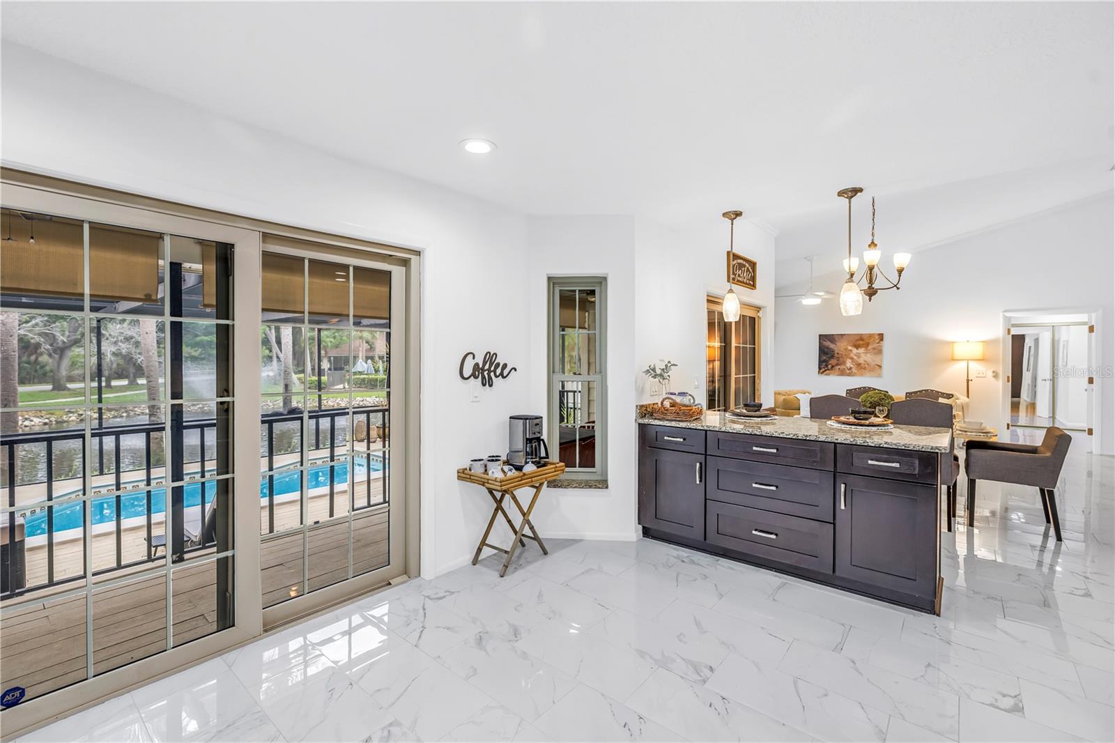 Vaulted Ceilings, Pool and Water View from Kitchen and Seamless open Living Dining with Views and Impact Sliders