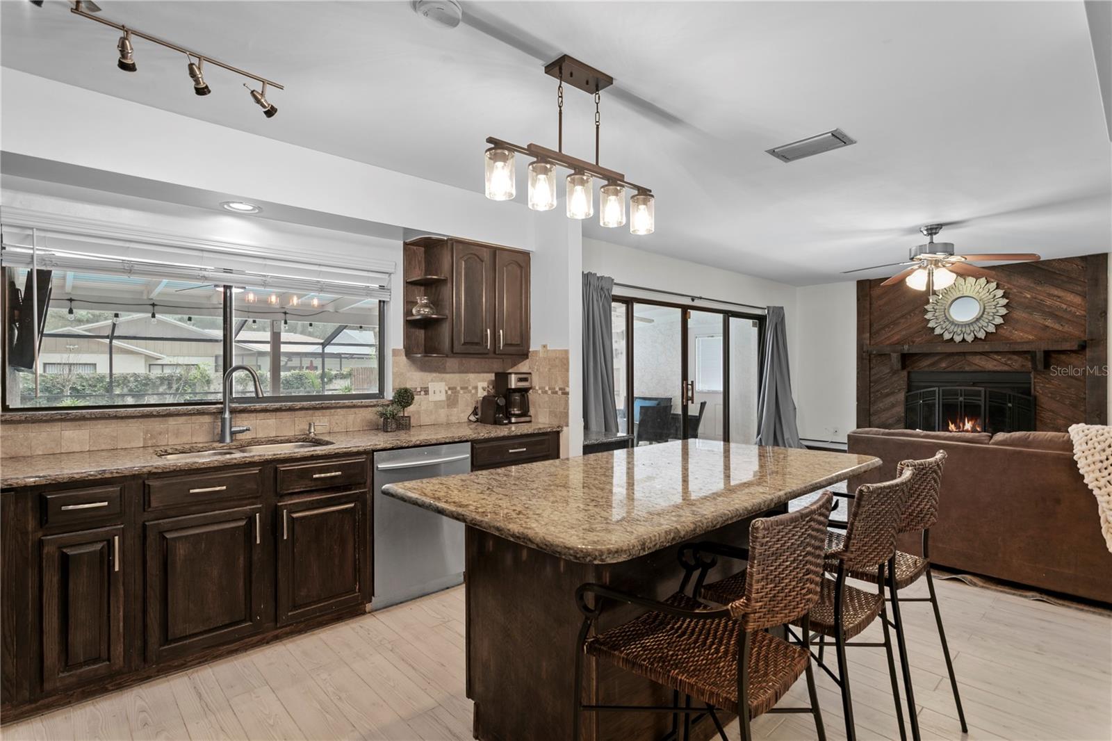 Kitchen features granite counters and a large kitchen island