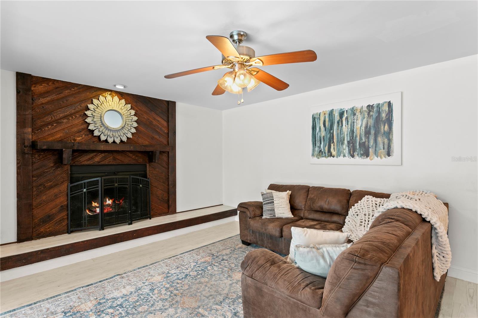 Family room features ceramic tile flooring and ceiling fan
