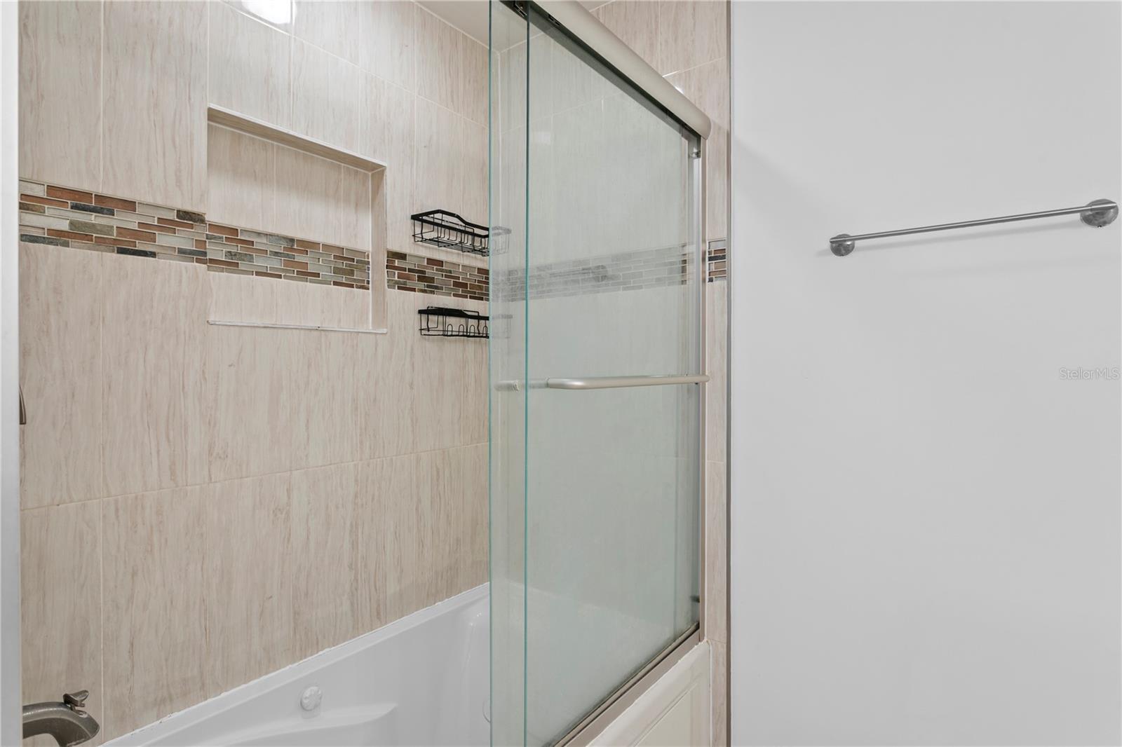 Primary bath tiled shower with bath