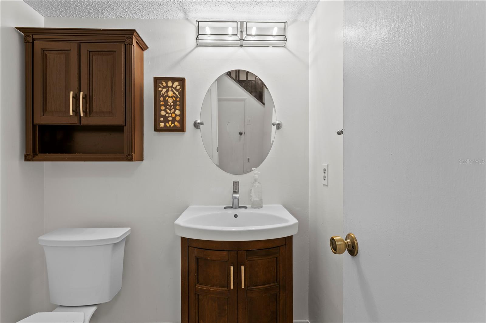 Downstairs half-bath off entry foyer