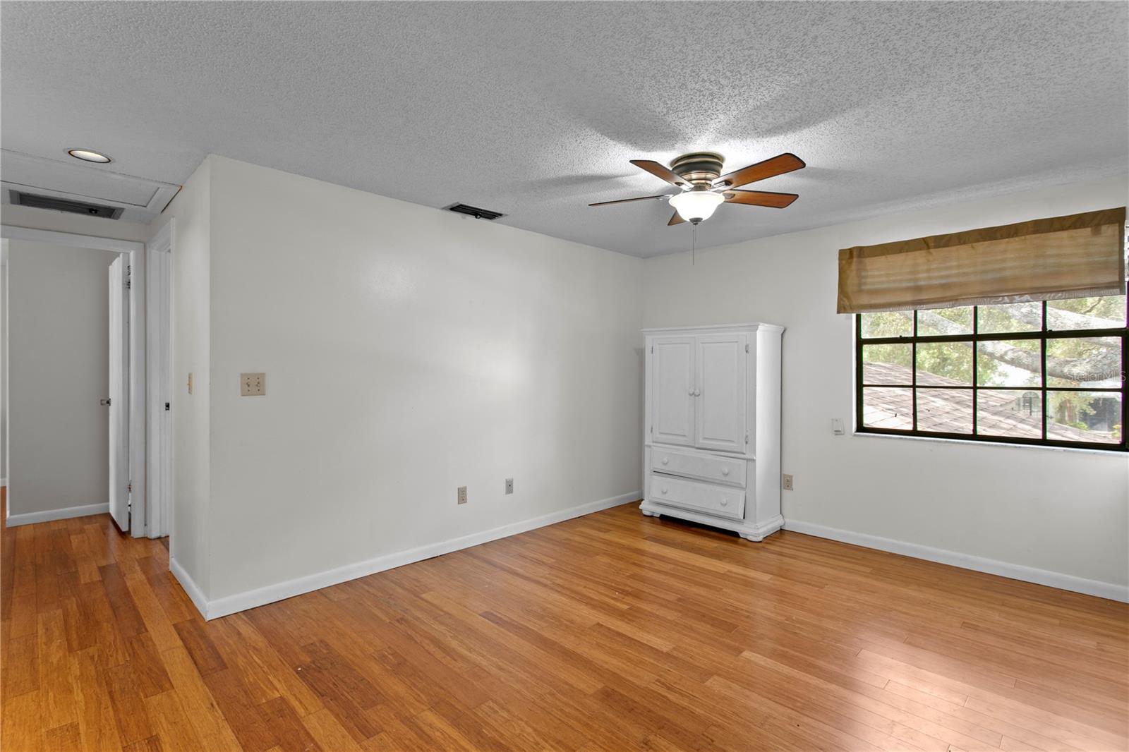Second floor loft features a ceiling fan